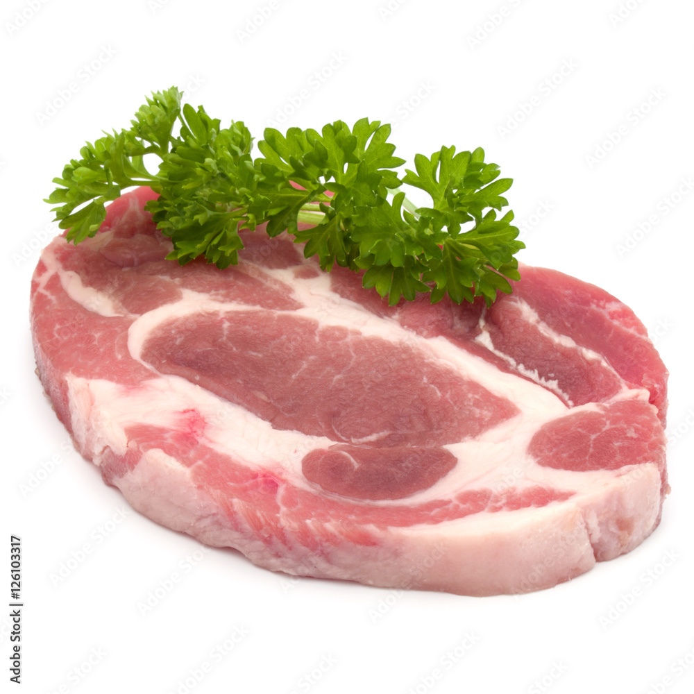 Raw pork neck chop meat with parsley herb leaves garnish isolate