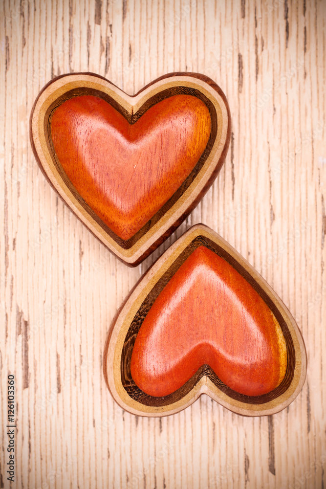 Fototapeta premium Two wooden hearts on rustic wood background. Valentines days con
