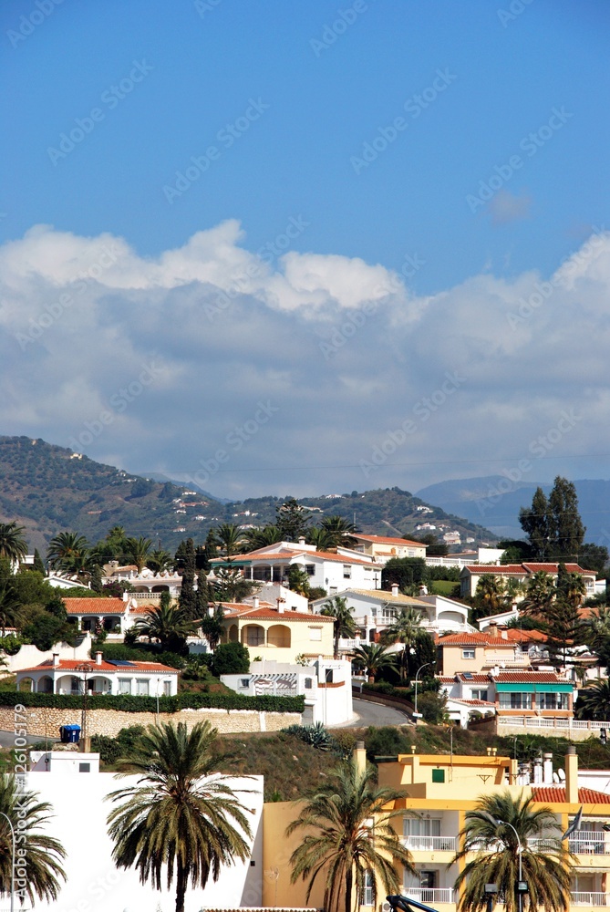 View of villas and apartments on the hillside with mountains to the rear, Caleta de Velez, Spain.