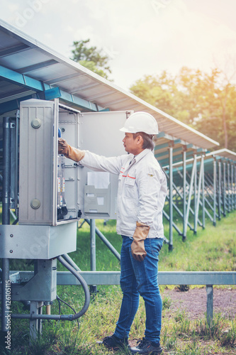 engineer or electrician working on maintenance equipment at industry solar power