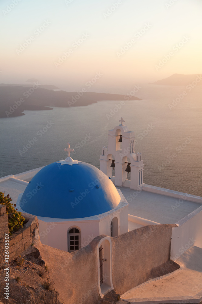 Famous church in Fira, Santorini at dust with a perfect view of