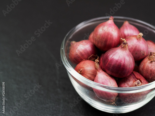 Shallot in a glass bowl with dark background