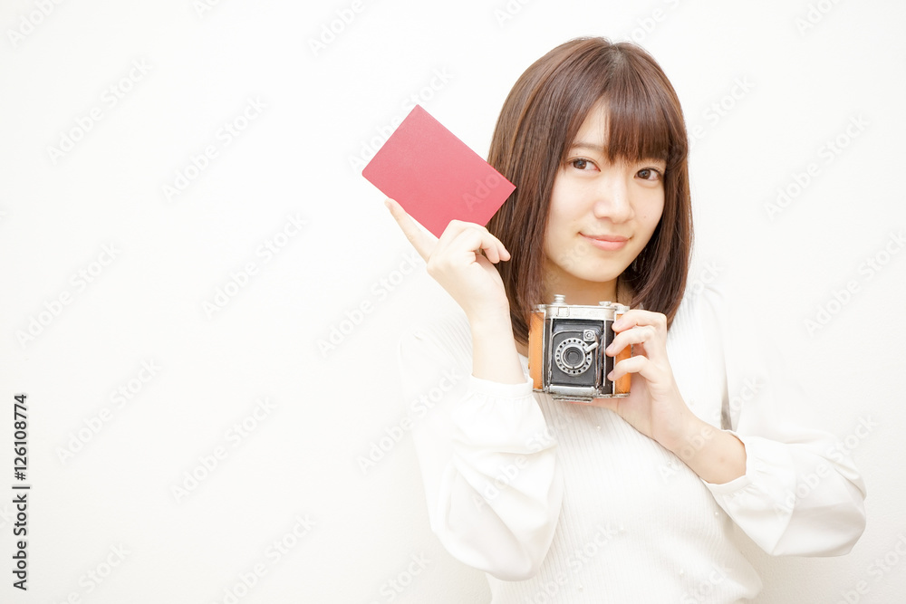 Young woman holding her passport with smile