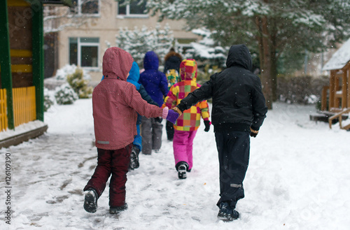 Children on walk in kindergarten in the winter.