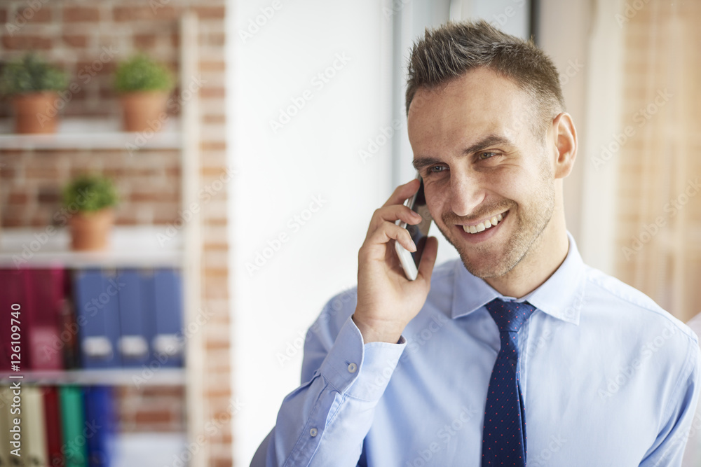 Cheerful man talking on the phone Cheerful man talking on the phone
