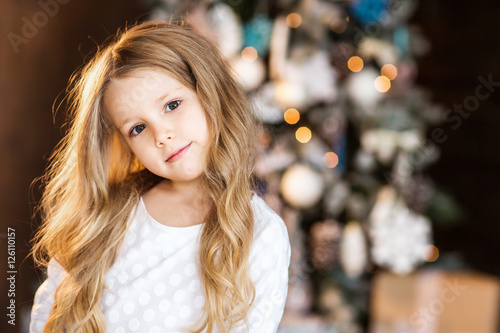 Portrait of little girl near christmas tree © Natalia Chircova