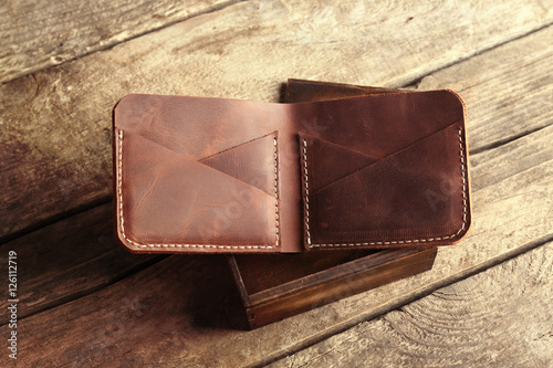 Leather wallet on wooden ba...