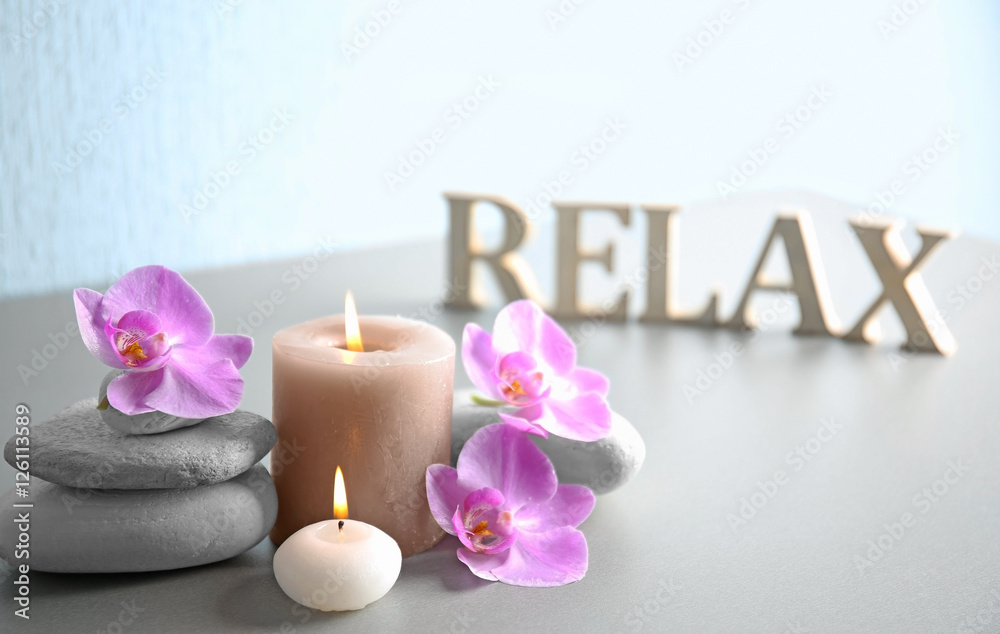 Spa composition and word RELAX made of wooden letters on table Spa composition and word RELAX made of wooden letters on table
