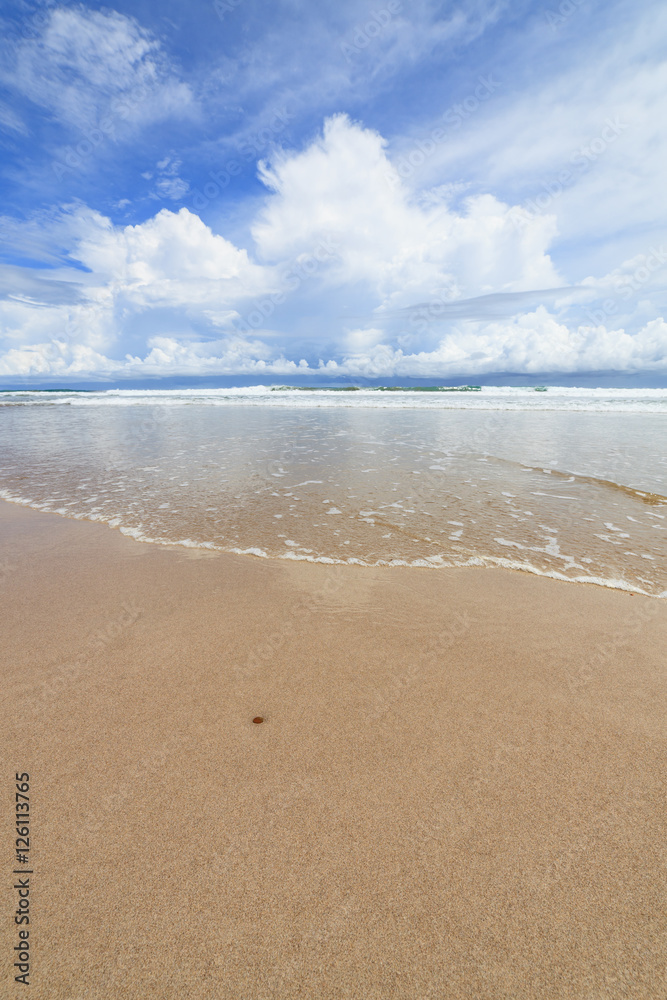 Waves sand beach and clouds sunny day