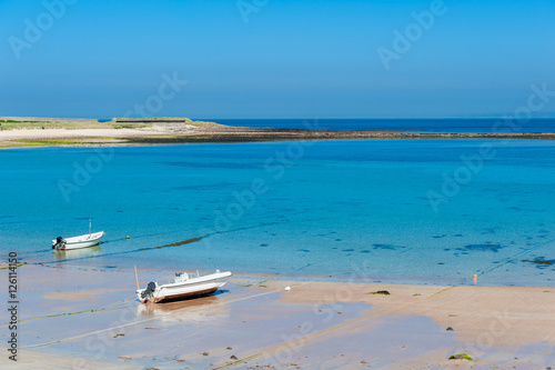 Coastline of Alderney  Channel Islands  UK at low tide on summer day.