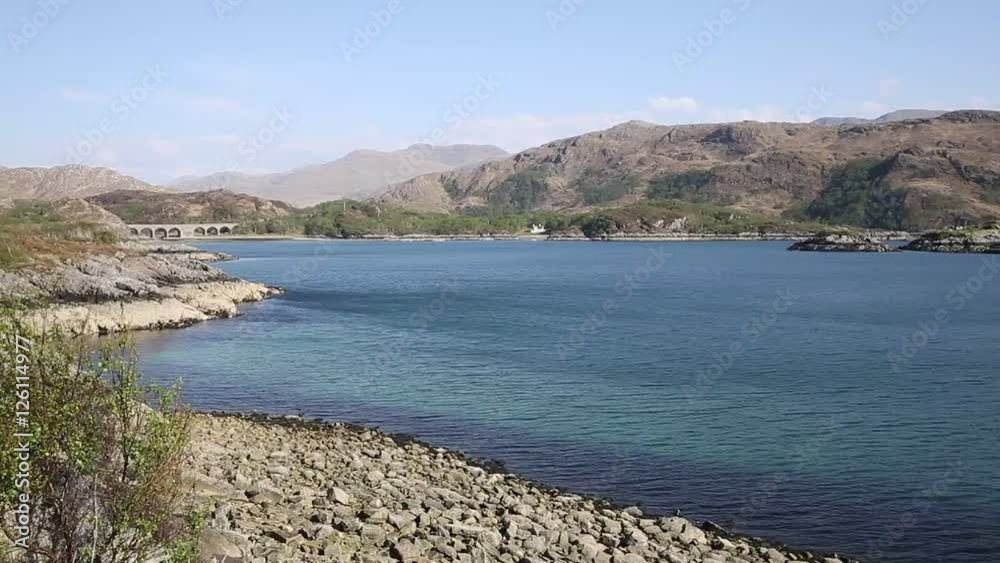 Loch Nan Uamh west coast of Scotland near Arisaig view to railway viaduct pan