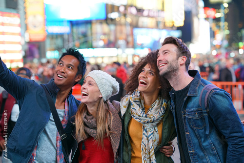 Group of friends having fun at Times Square, NYC © goodluz