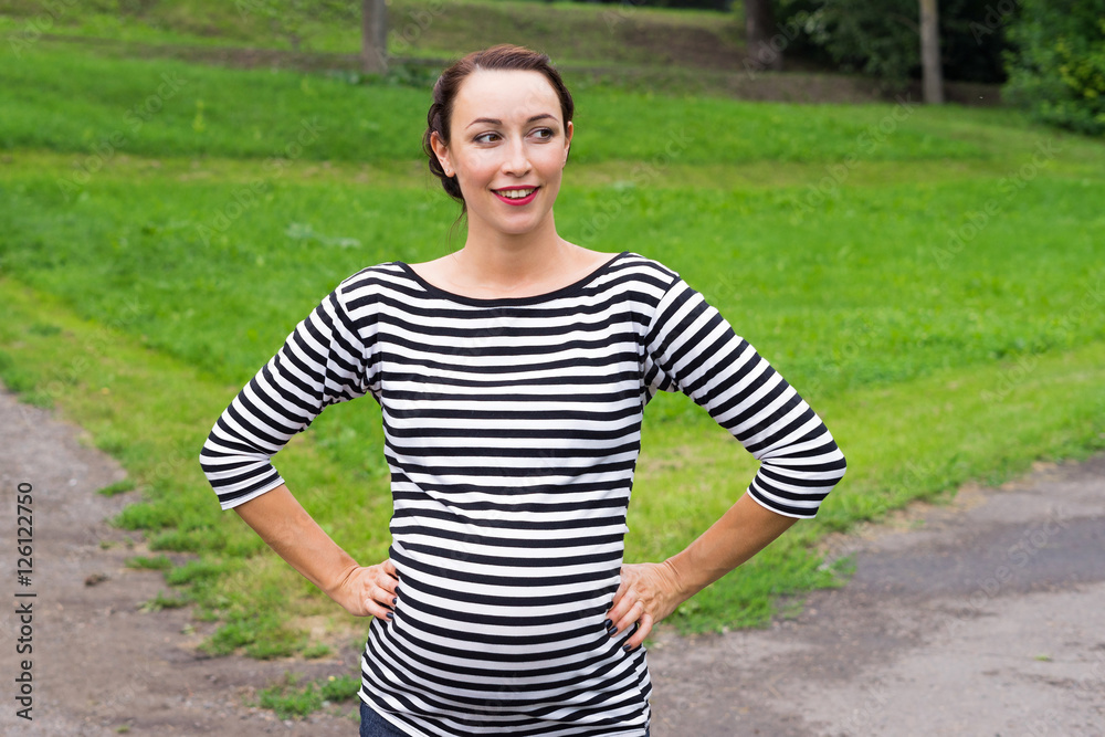 Pregnant woman with hands on waist Pregnant woman with hands on waist