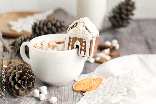 Big mug of hot cocoa with marshmallow decorated with mini ginger