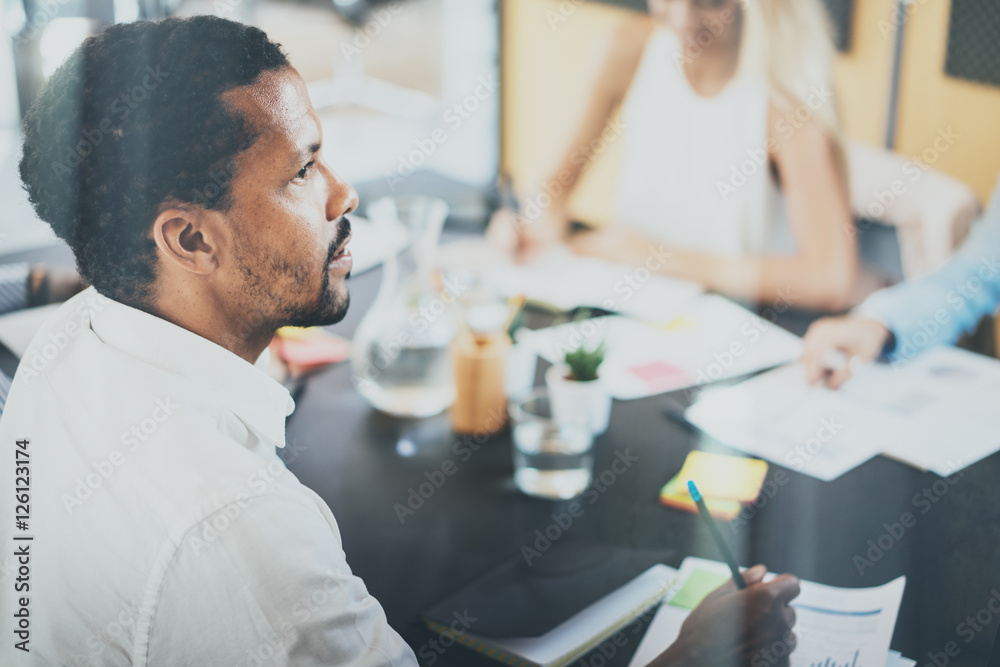 Black african project manager during business meeting in a modern office.Horizontal,blurred background.