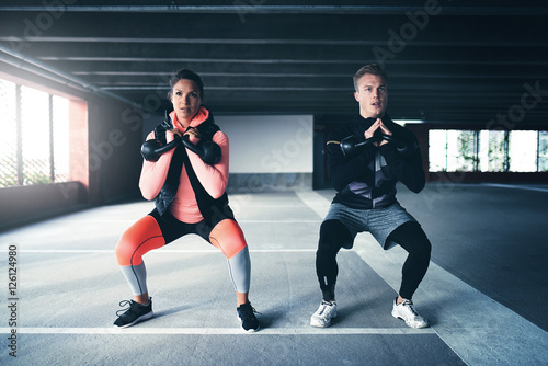 Man and woman exercising with weights