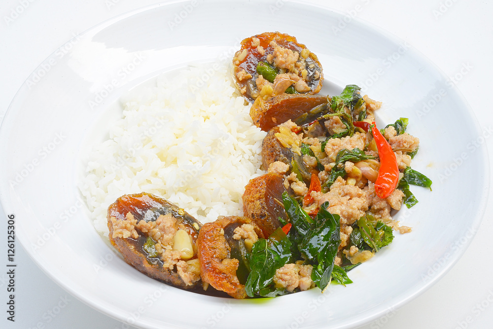 Rice topped with stir-fried preserved egg slice and basil.
Rice topped with stir-fried preserved egg slice and basil.