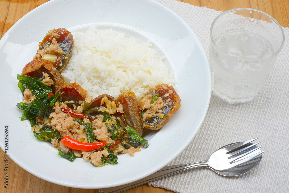 Rice topped with stir-fried preserved egg slice and basil.
Rice topped with stir-fried preserved egg slice and basil.