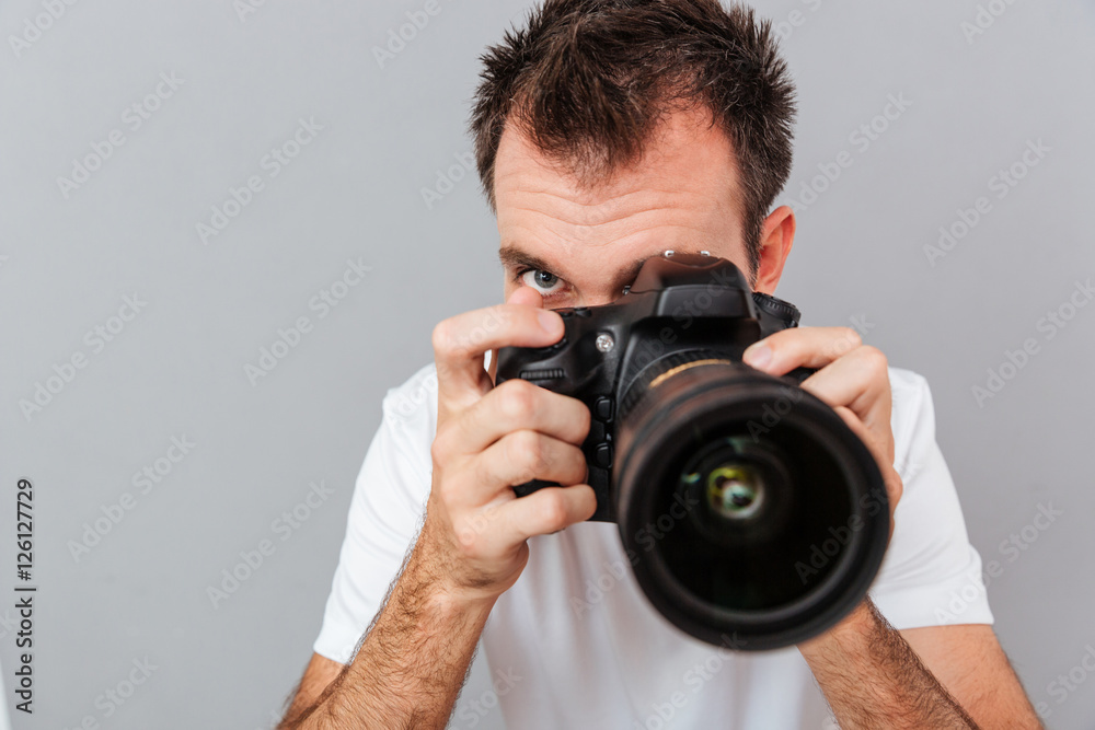 Portrait of a young photographer with camera