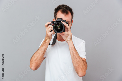 Portrait of a young photographer with camera