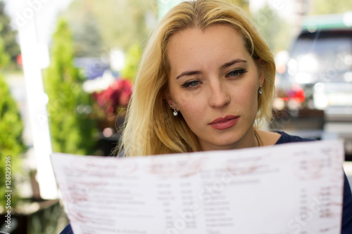 blonde woman choosing from the menu