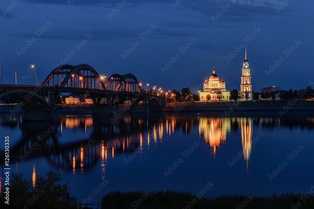 City landscape. City at night, the bridge across the river, the cathedral was consecrated.