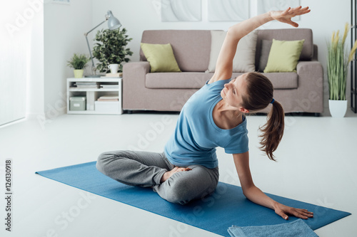Fototapeta Naklejka Na Ścianę i Meble -  Woman practicing yoga at home