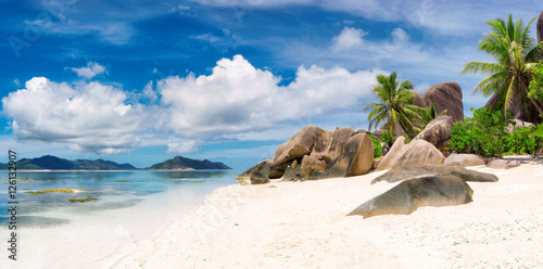 Panorama of tropical beach at Seychelles, La Digue island and Praslin island on the horizon.