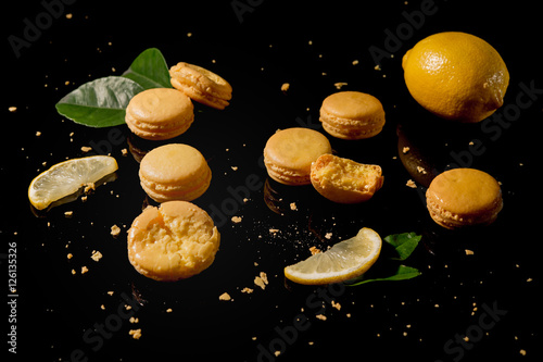 yellow Macaroon with lemon on a black background shot from above