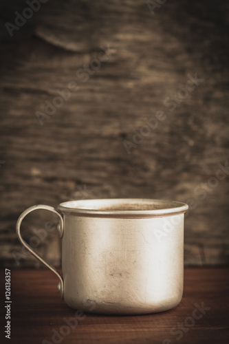 old iron Cup on wooden background