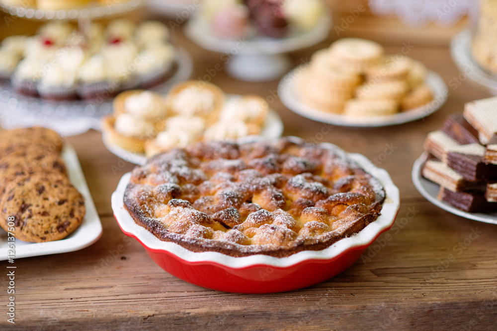 Table with sweet pie, tarts and cookies, wooden background. Table with sweet pie, tarts and cookies, wooden background.