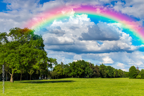 Green grass field, blue sky rainbow, background nature, cloudy park, outdoor for design