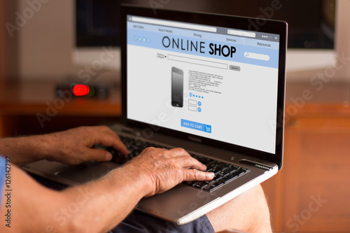 Cropped image of a senior man using his laptop at home and shopp
