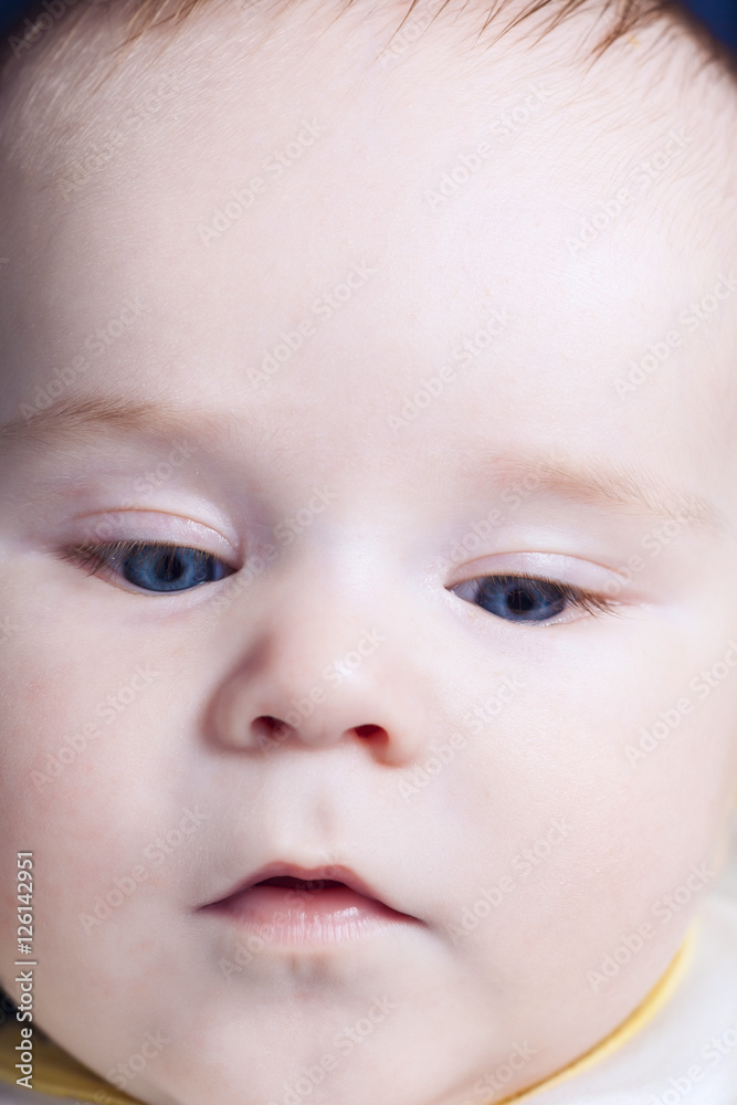 Closeup of baby boy face looking down Closeup of baby boy face looking down