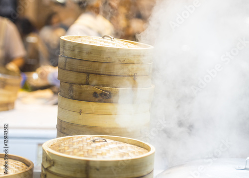 Asian street food - steamed dumplings in Beijing, kitchen interior in China