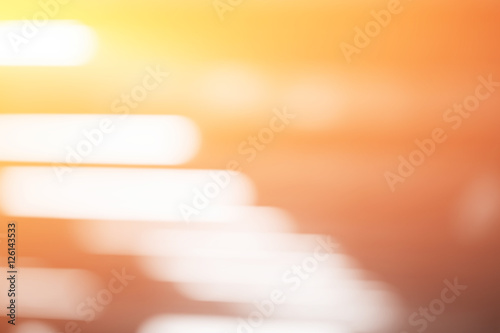Diagonal warm orange office lamps bokeh background