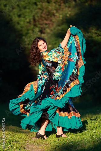 Beautiful gypsy girl in a traditional dance in the woods