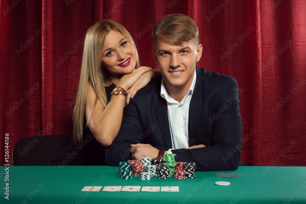Young couple playing poker at the casino Young couple playing poker at the casino