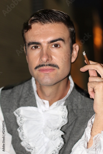 Obraz na plátne Elegant gentleman holding a cigar. Victorian Era