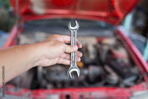 Wallpaper Mural Wrench in hand on the background of cars Torontodigital.ca