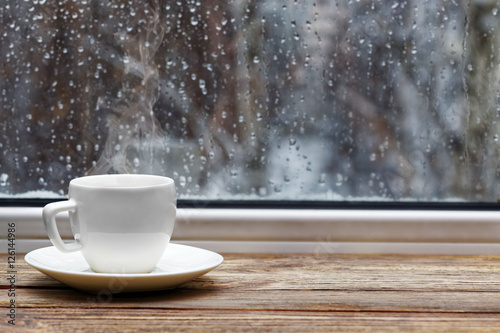 White cup on wooden windowsill