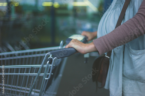 Pregnant woman with shopping trolley