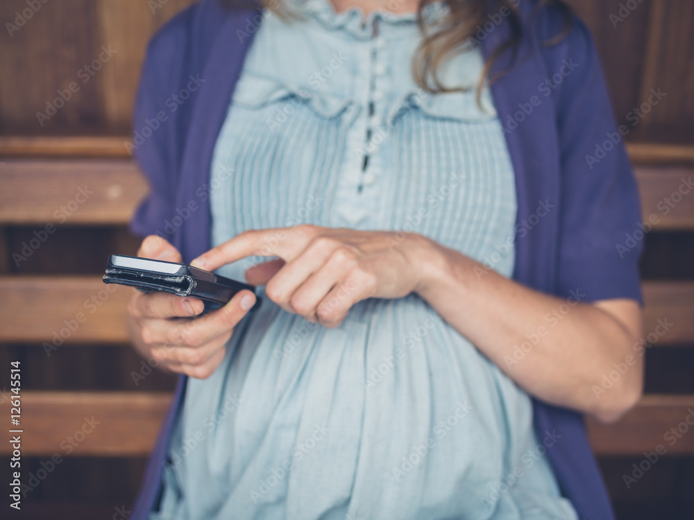 Pregnant woman with smartphone Pregnant woman with smartphone