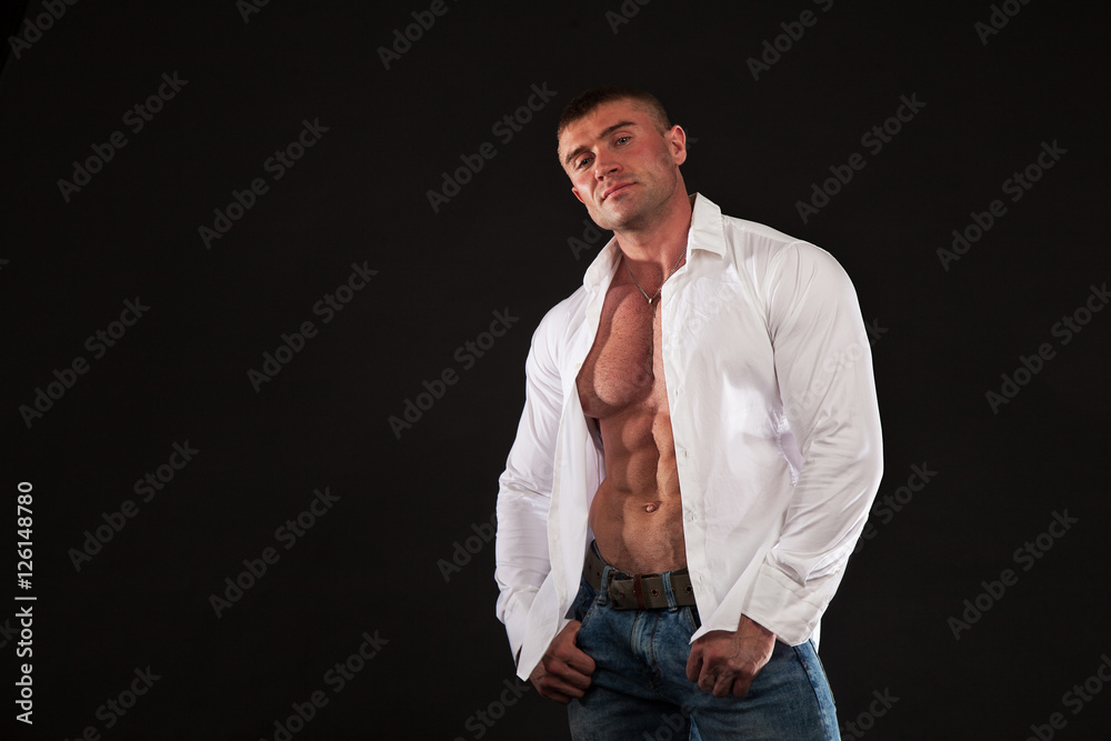 Big sexy man with huge muscules shows abs. Bodybuilding, sports, gym. Healthy lifestyle concept Big sexy man with huge muscules shows abs. Bodybuilding, sports, gym. Healthy lifestyle concept