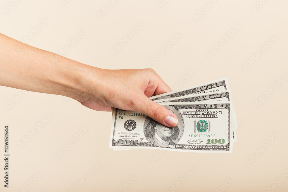 Φωτογραφία Woman's hand with money on a light background