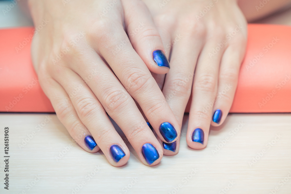 female hands with blue nail Polish, close-up female hands with blue nail Polish, close-up