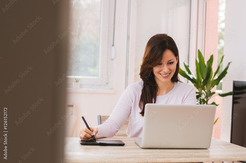 Smiling woman working from her home office.