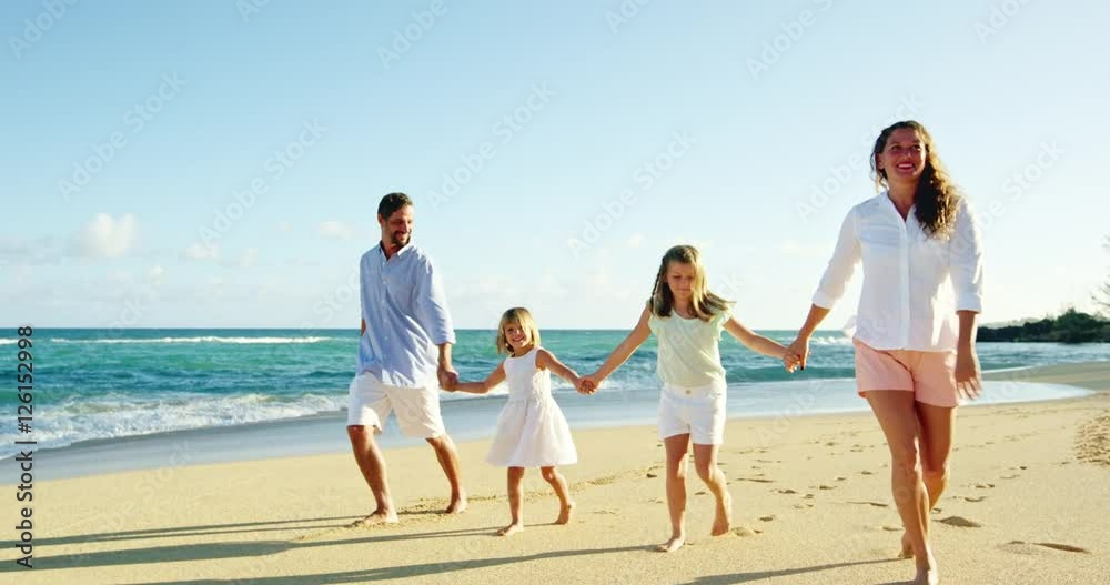 Happy family enjoying morning walk on the beach Happy family enjoying morning walk on the beach