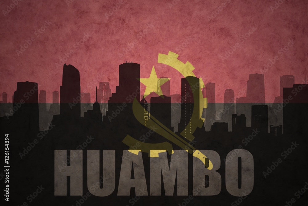 abstract silhouette of the city with text Huambo at the vintage angolan flag