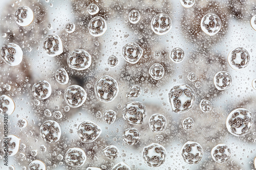 Colorful candies reflected in the water drops.